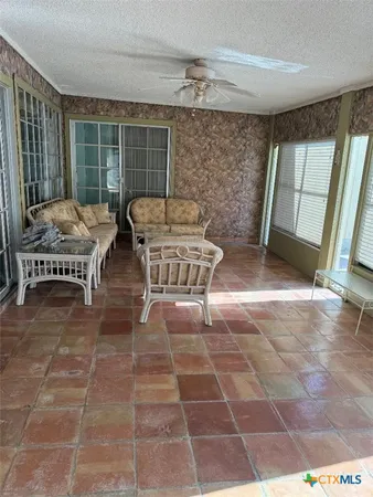 a living room with a large window and a table