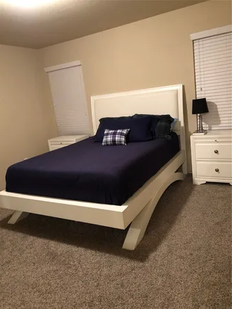 a bedroom with a bed and window