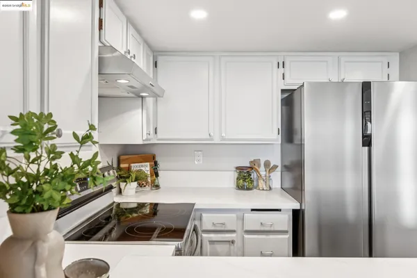 a kitchen with stainless steel appliances kitchen island a stove a sink and a refrigerator