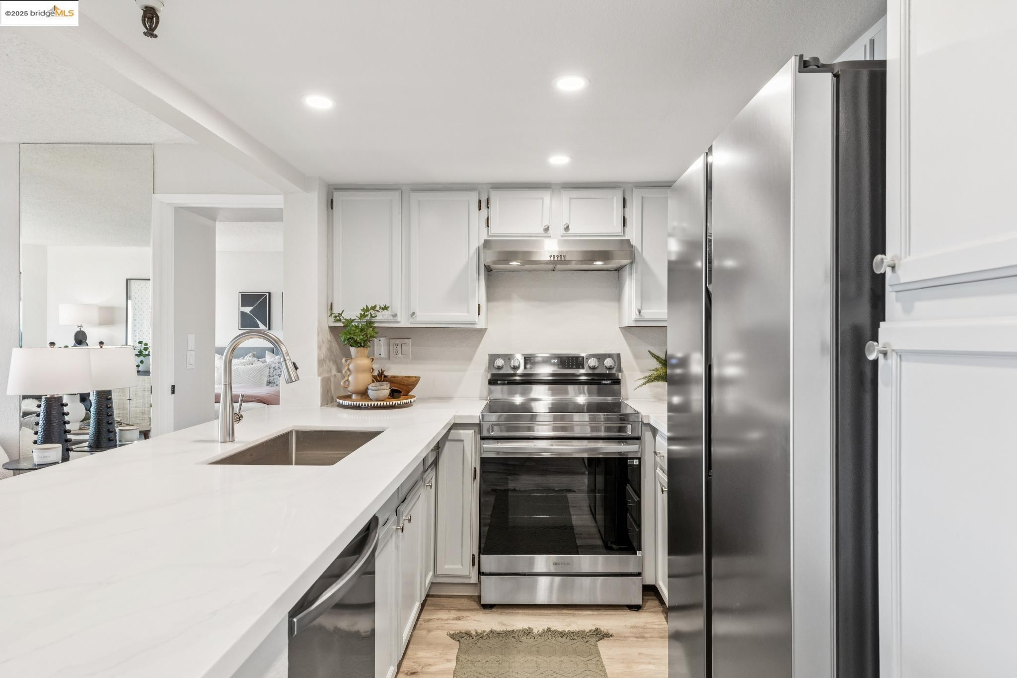 545 Pierce Street, Unit 1206 Albany, CA 94706 - Photo 18 of 44 a kitchen with stainless steel appliances granite countertop a sink a stove and a refrigerator