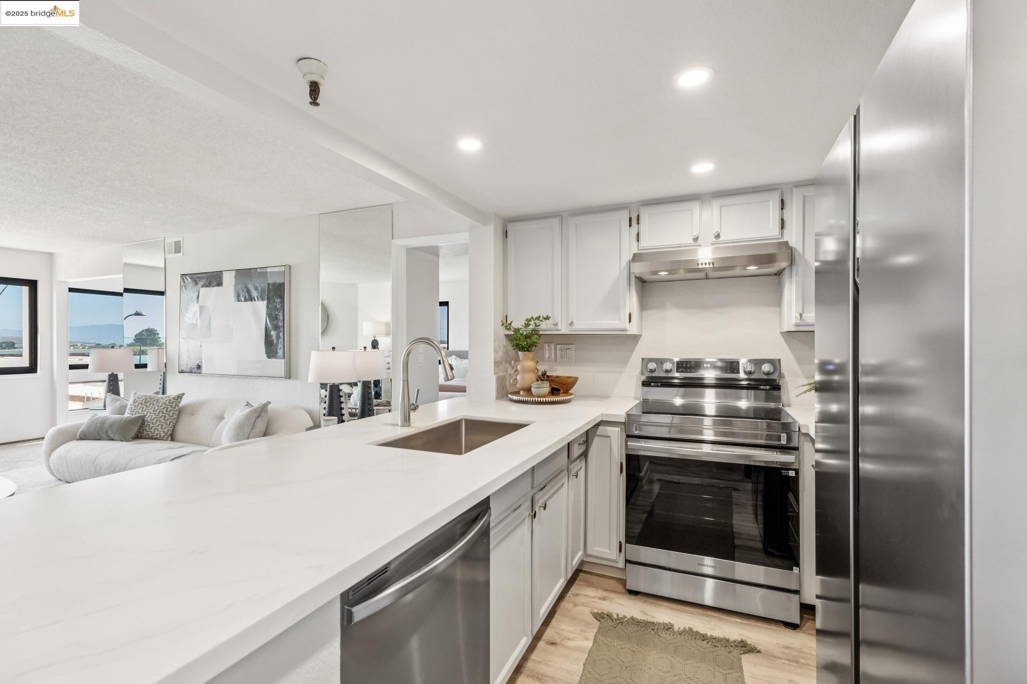 545 Pierce Street, Unit 1206 Albany, CA 94706 - Photo 19 of 44 a kitchen with stainless steel appliances kitchen island a stove a sink and a refrigerator