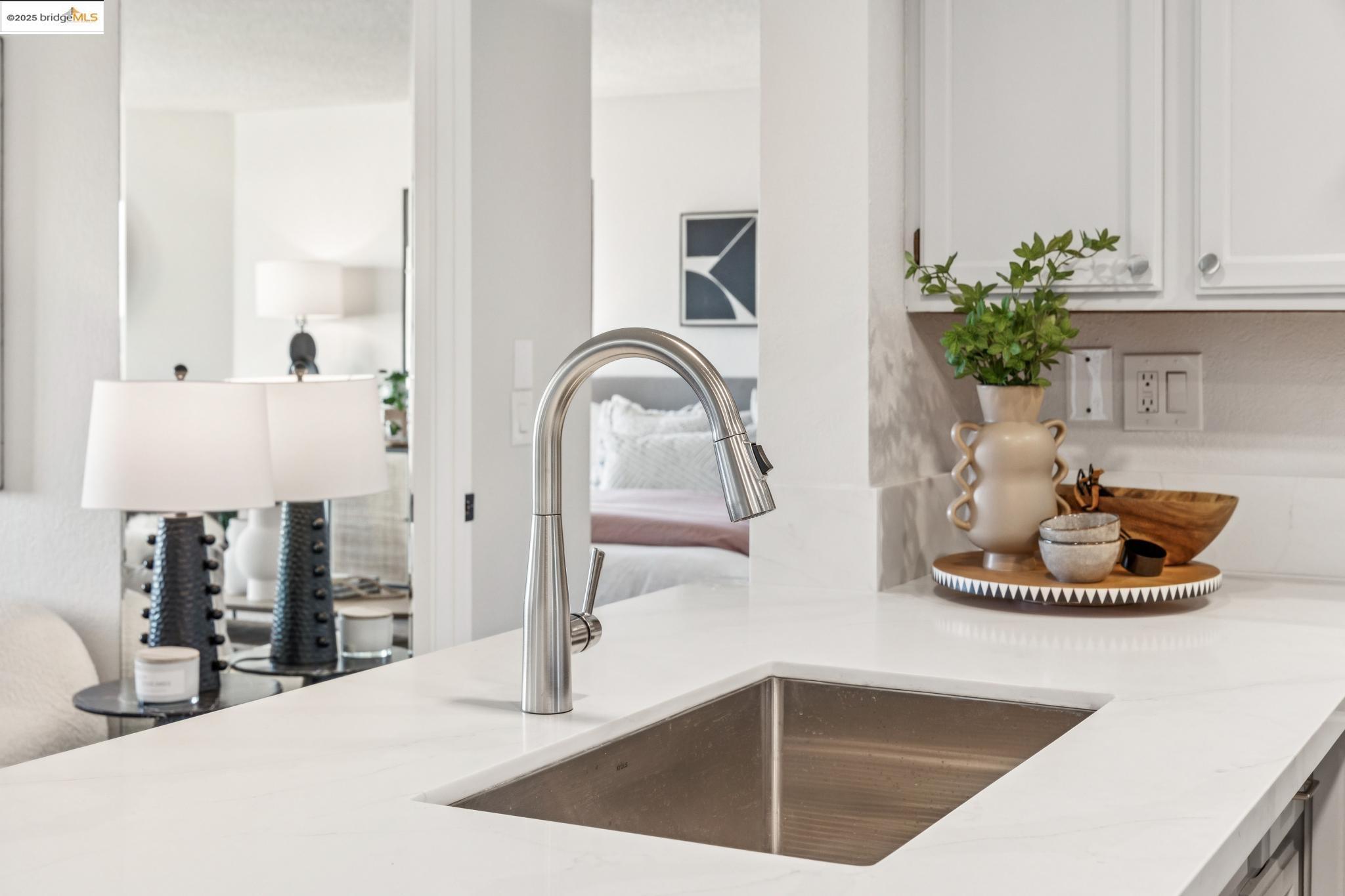 545 Pierce Street, Unit 1206 Albany, CA 94706 - Photo 20 of 44 a kitchen with kitchen island a sink and white cabinets