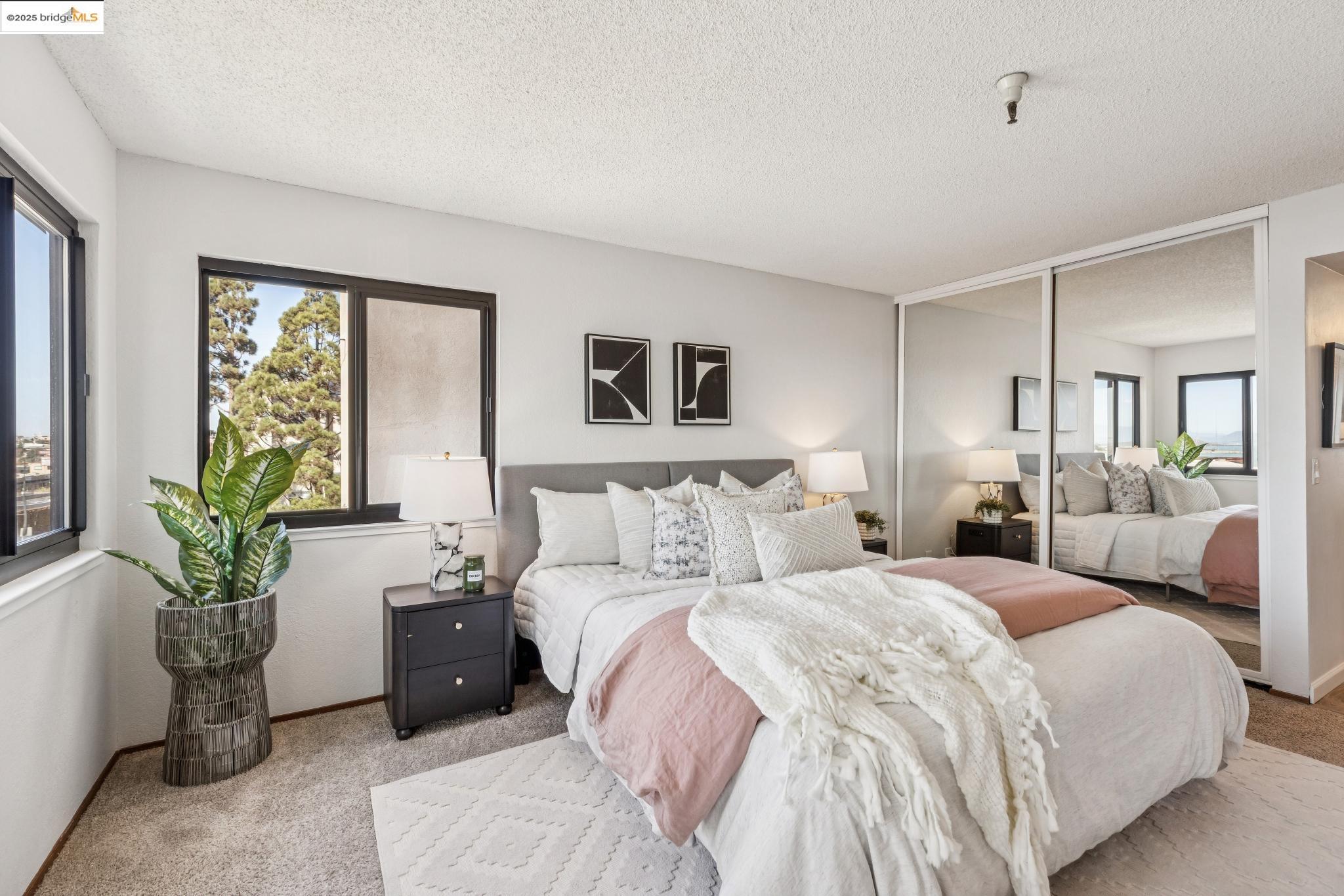 545 Pierce Street, Unit 1206 Albany, CA 94706 - Photo 25 of 44 a bedroom with a large bed and a potted plant