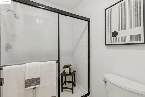 a bedroom with a bed and a night stand