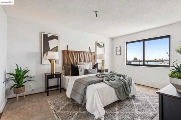 a bedroom with a bed and a mirror