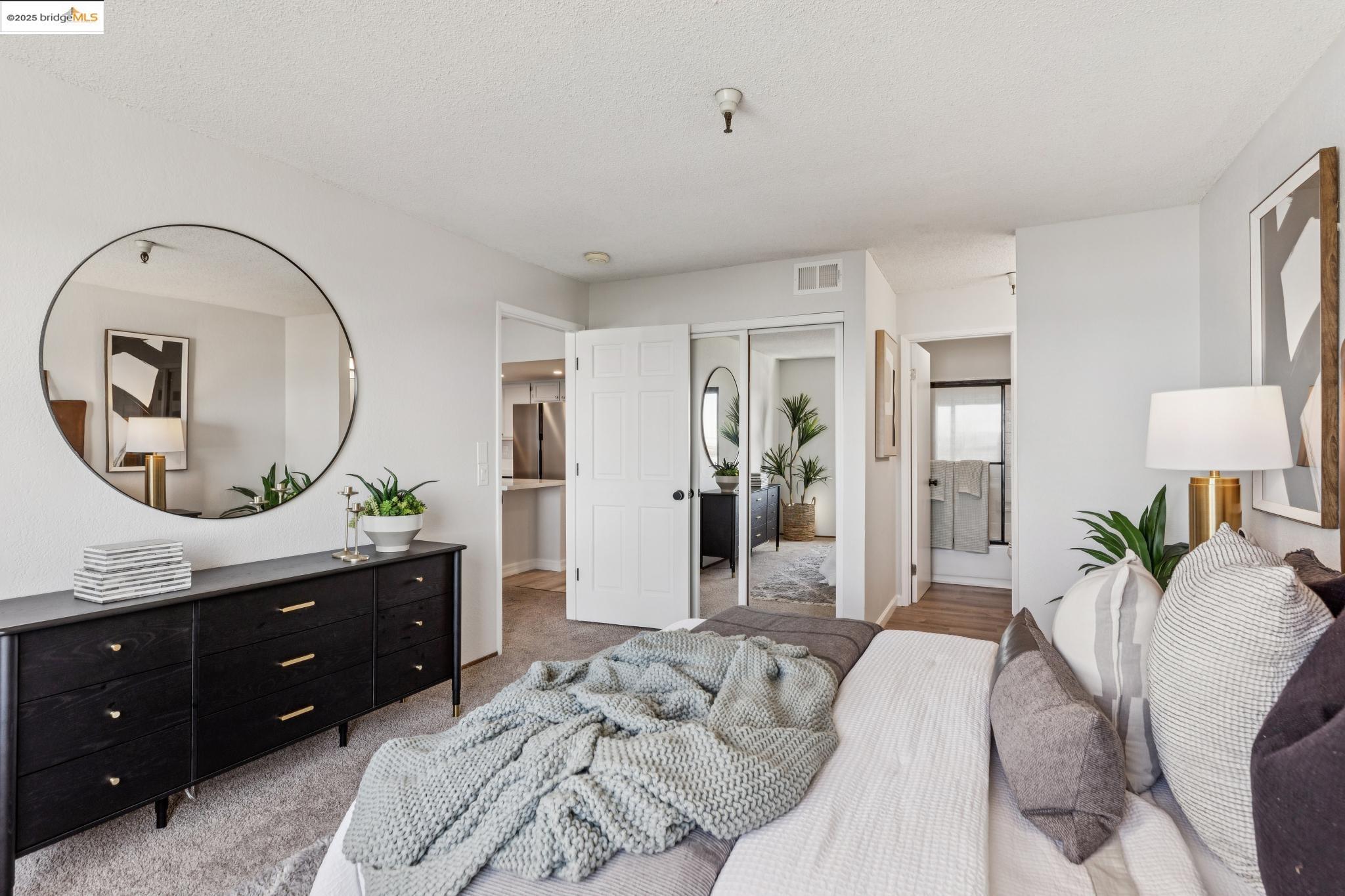 545 Pierce Street, Unit 1206 Albany, CA 94706 - Photo 31 of 44 a bedroom with a bed and a mirror