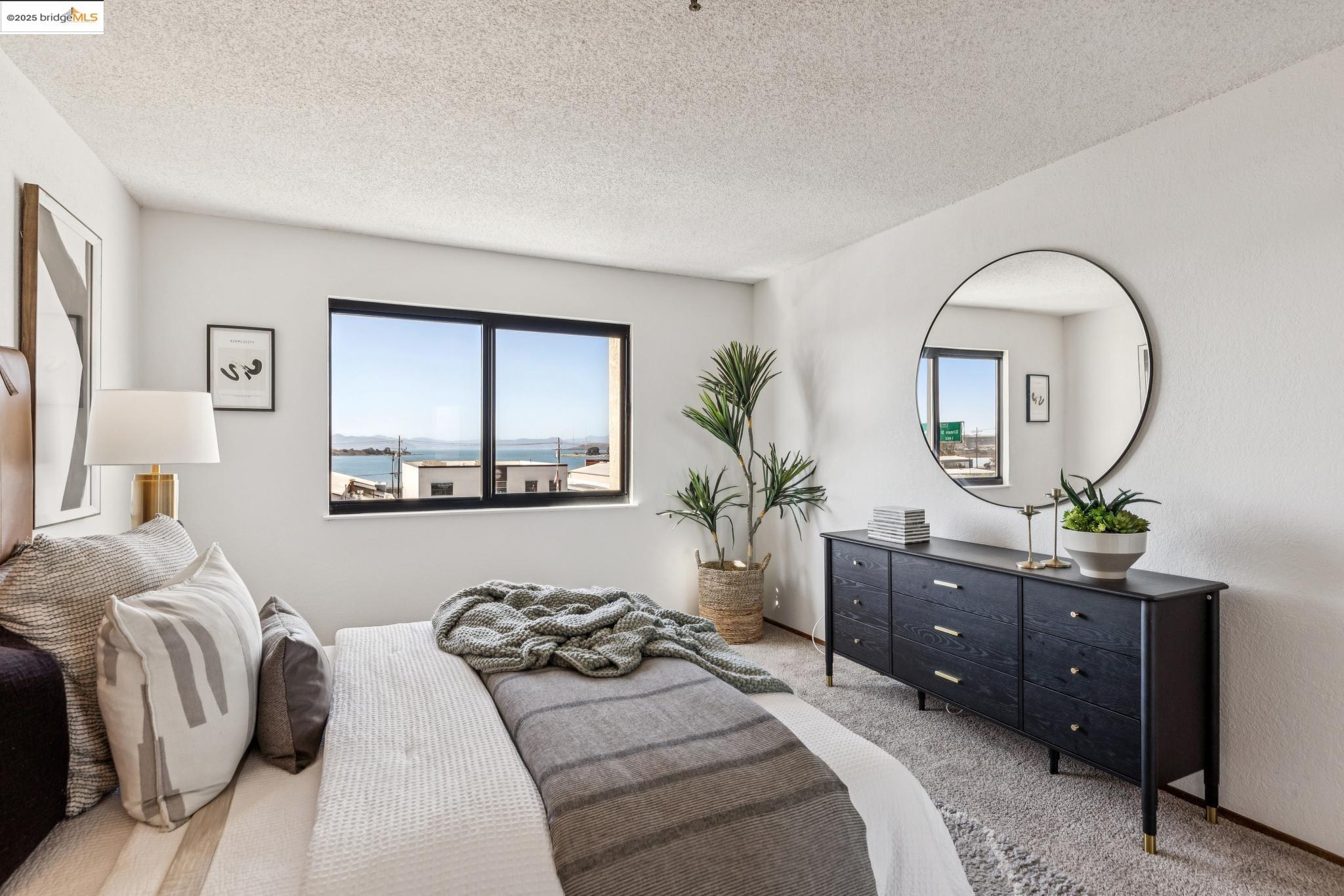 545 Pierce Street, Unit 1206 Albany, CA 94706 - Photo 32 of 44 a bedroom with a bed and a mirror on dresser