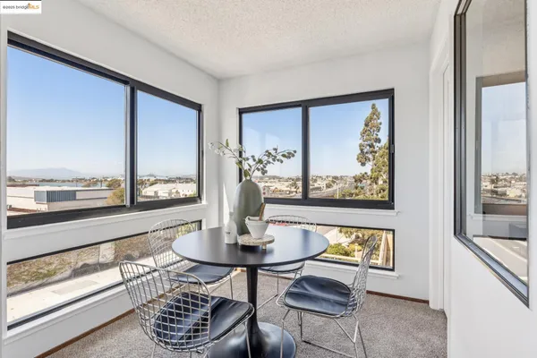 a view of a balcony with floor to ceiling windows