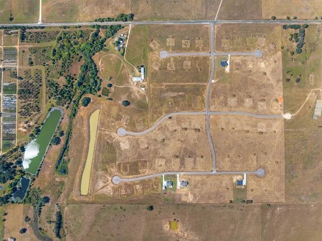 an aerial view of residential houses with outdoor space