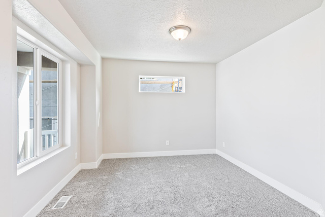 257 North Slant Road, Unit 51M Mapleton, UT 84660 - Photo 12 of 24 Spare room featuring light colored carpet and a textured ceiling