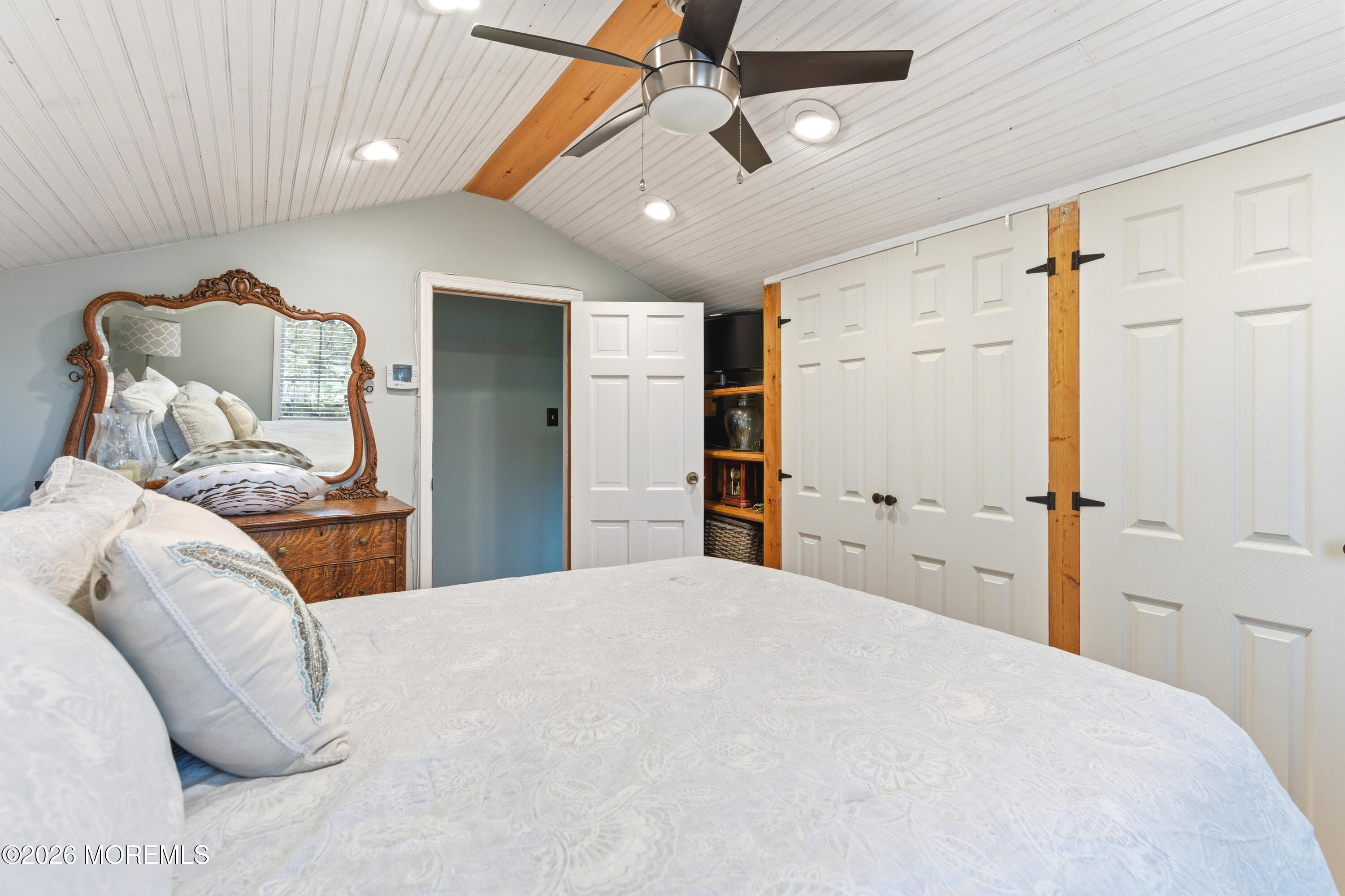 114 Ocean Boulevard Keyport, NJ 07735 - Photo 19 of 41 a bedroom with a large bed and a chandelier