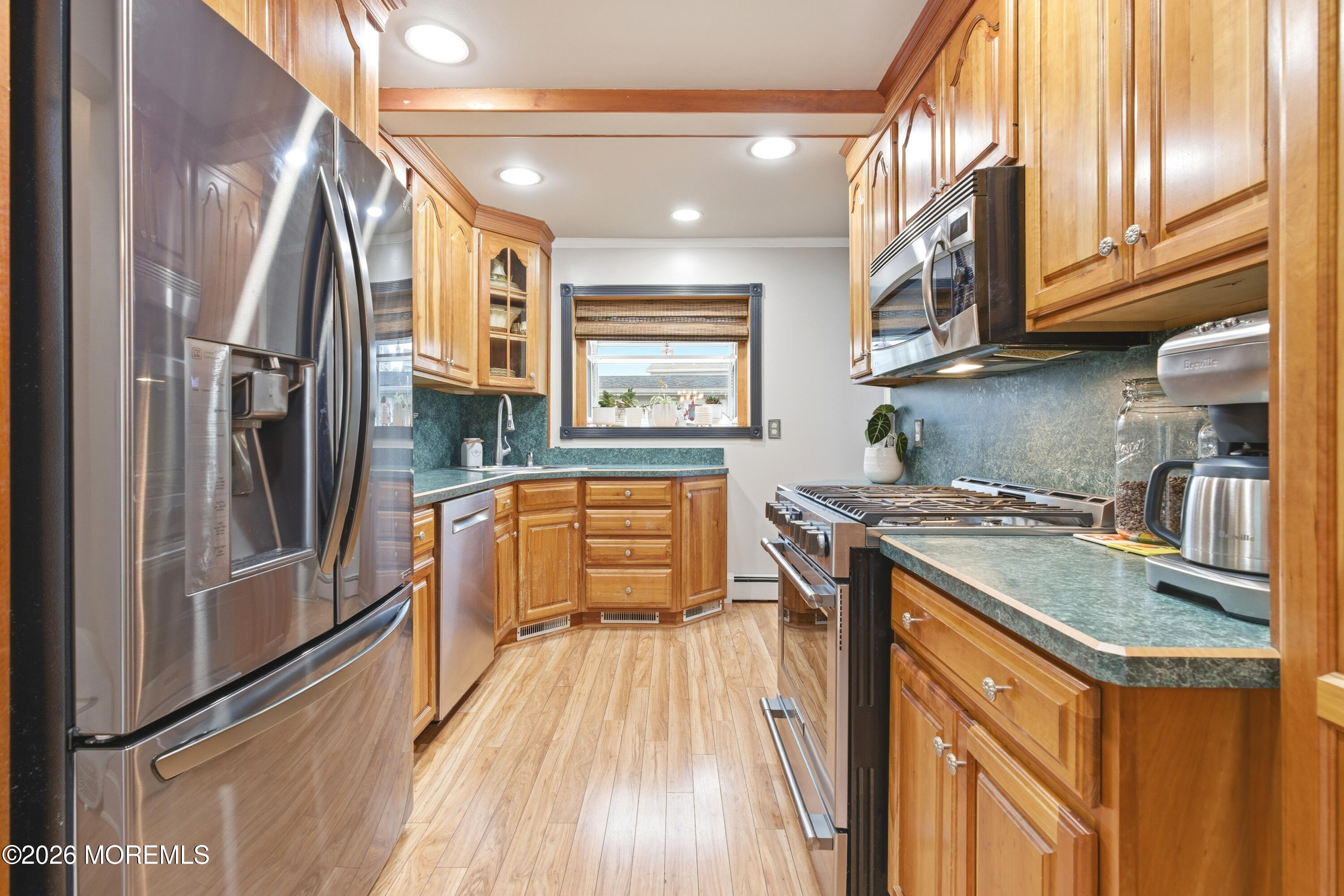 114 Ocean Boulevard Keyport, NJ 07735 - Photo 9 of 41 a kitchen with stainless steel appliances granite countertop a refrigerator a stove and a sink with wooden floor