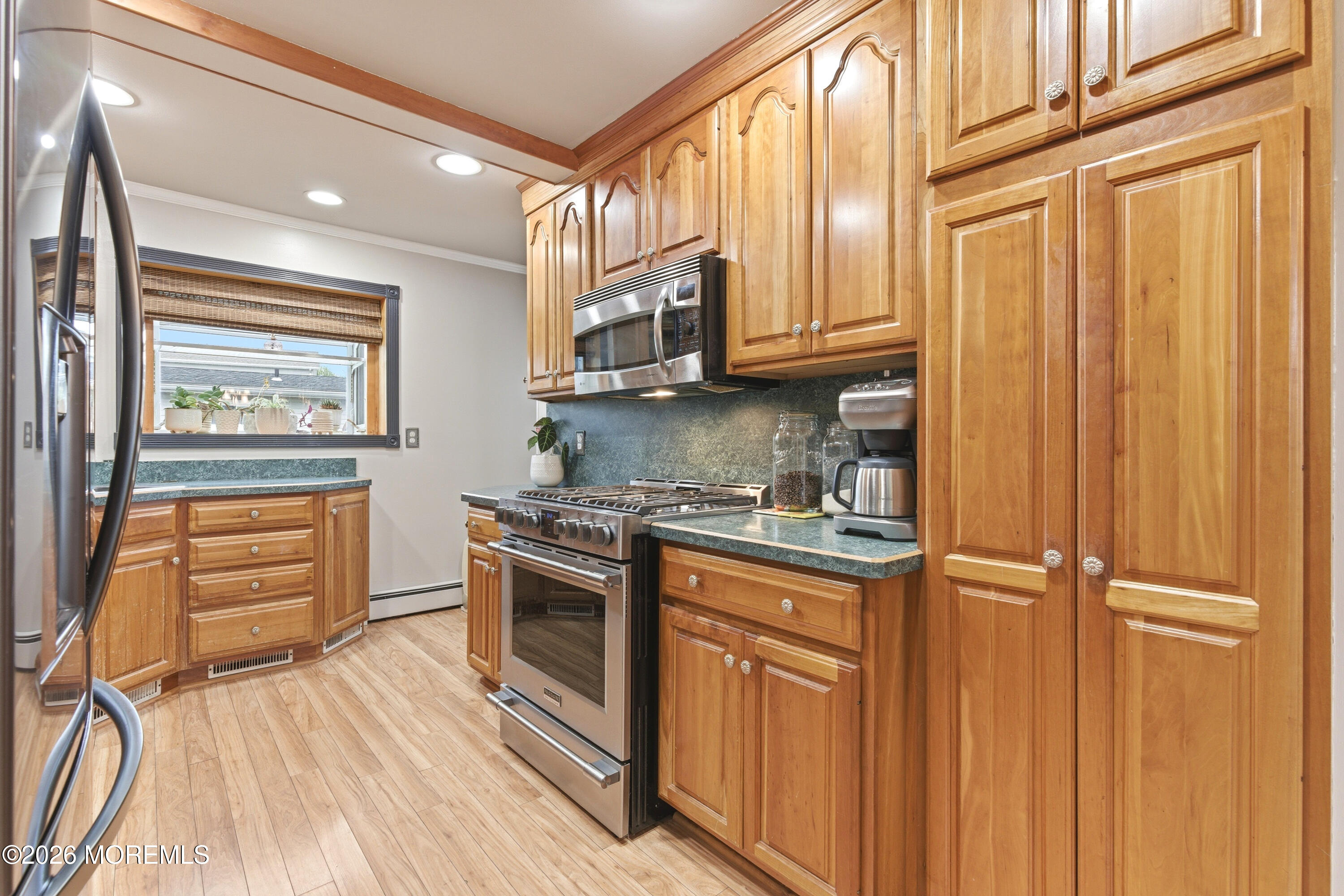 114 Ocean Boulevard Keyport, NJ 07735 - Photo 10 of 41 a kitchen with stainless steel appliances granite countertop cabinets and wooden floor