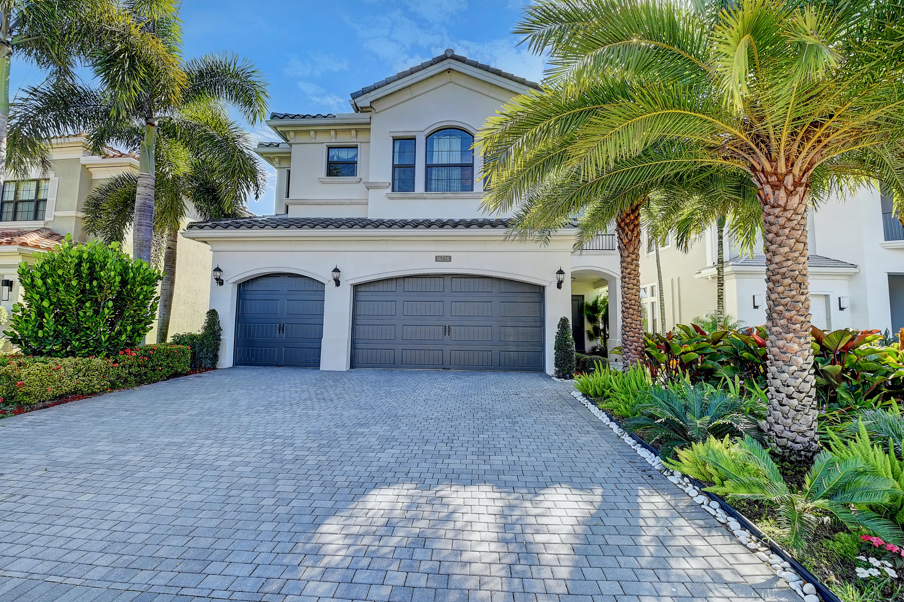 a front view of a house with yard and garage