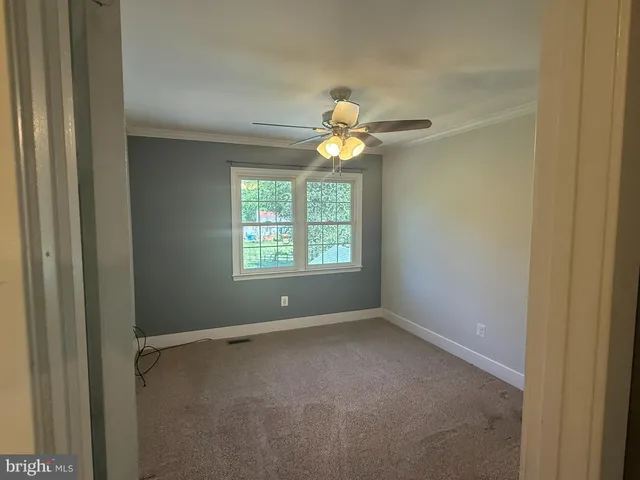 a view of room with window and ceiling fan