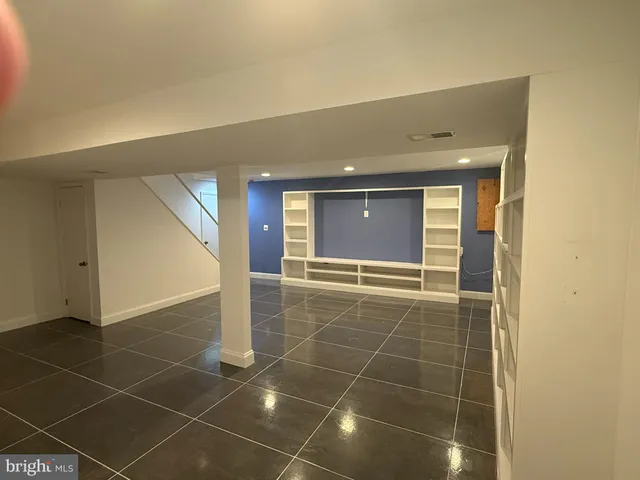 a bathroom with a glass door shower and a sink