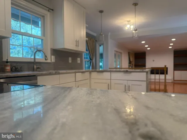 a kitchen with stainless steel appliances granite countertop a stove and a sink