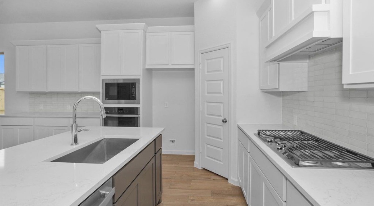 303 Eileen Drive Rosenberg, TX 77471 - Photo 3 of 17 a kitchen that has a sink and a stove