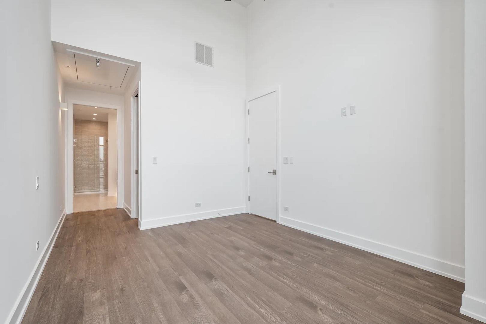 728 Waukegan Road, Unit 206 Deerfield, IL 60015 - Photo 15 of 18 an empty room with wooden floor & closet