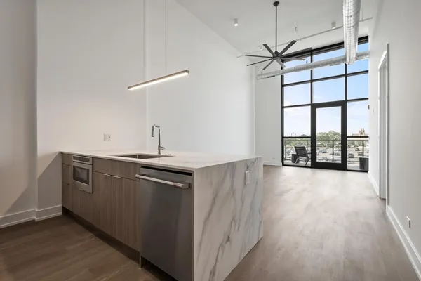 a view of a kitchen with a sink and wooden floor