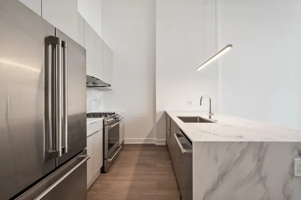 a kitchen with a sink and stainless steel appliances