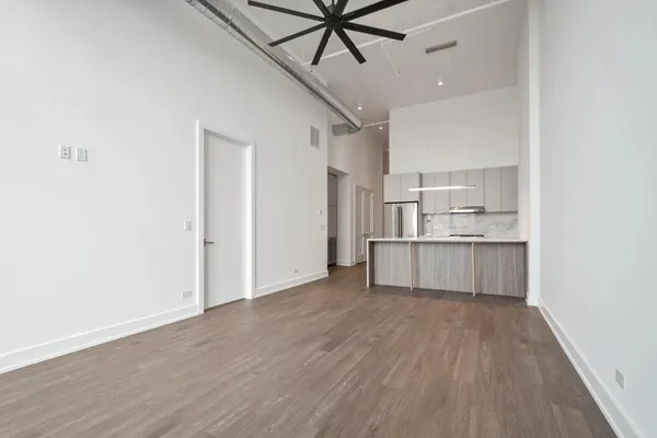 a view of kitchen with wooden floor and electronic appliances