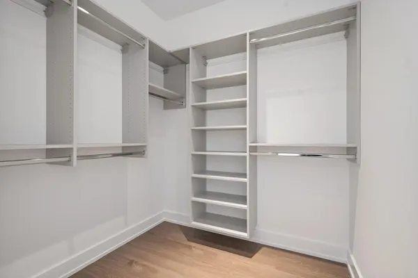 a view of walk in closet with empty racks