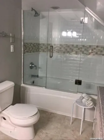 a bathroom with a toilet and shower