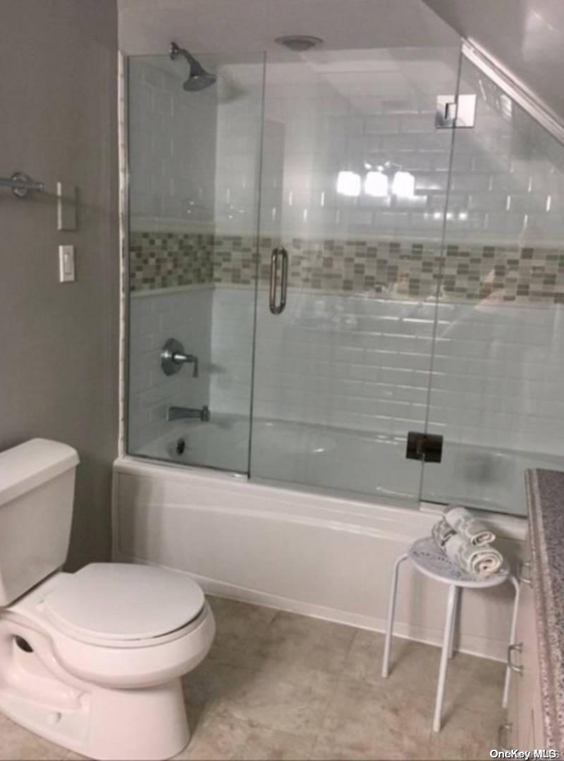114 Spinney Road East Quogue, NY 11942 - Photo 11 of 15 a bathroom with a toilet and shower
