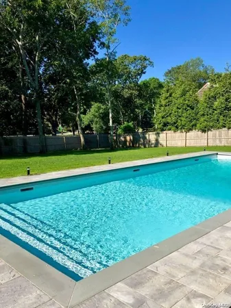 a view of a swimming pool with an outdoor space and seating area