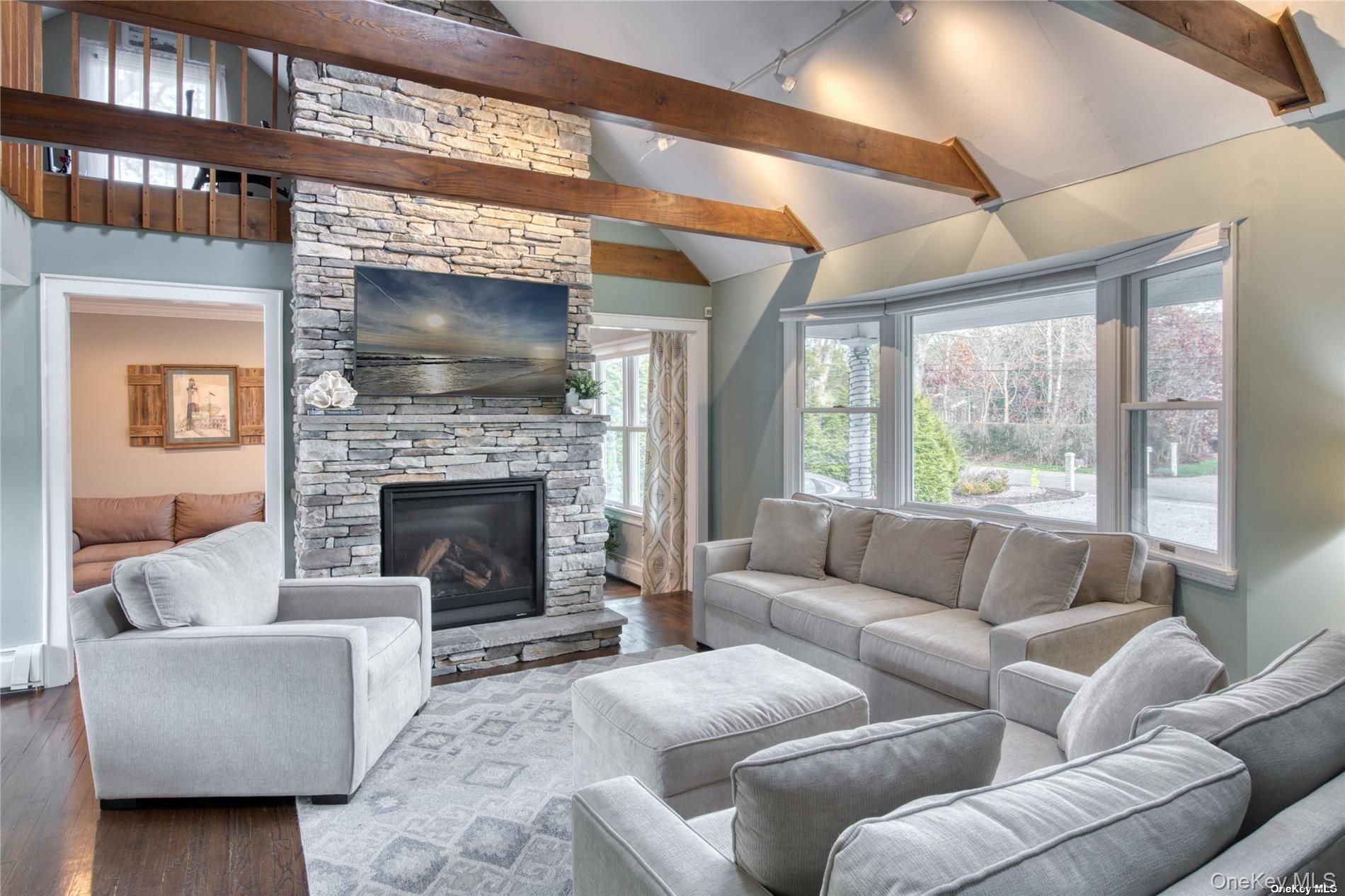 114 Spinney Road East Quogue, NY 11942 - Photo 3 of 15 a living room with furniture and a fireplace