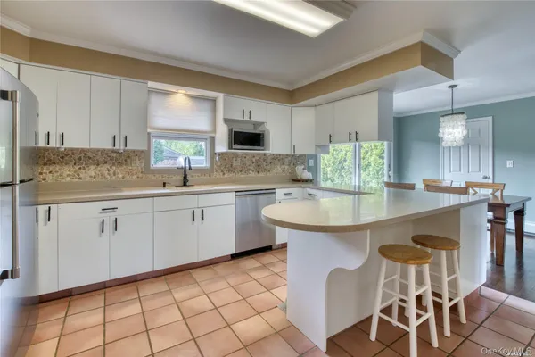 a kitchen with a sink cabinets and window