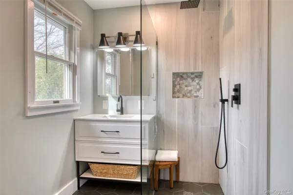 a bathroom with a shower tub and sink