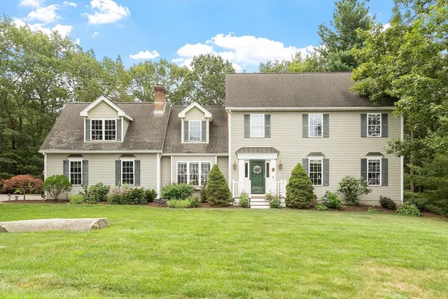 a front view of house with yard and green space