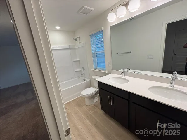 a bathroom with a sink a tub and a mirror