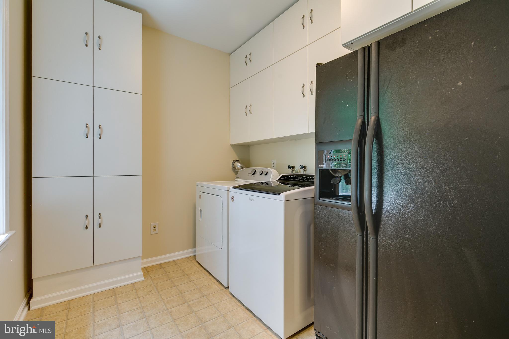 7007 Barnacle Place Burke, VA 22015 - Photo 19 of 49 a kitchen with a refrigerator and cabinets