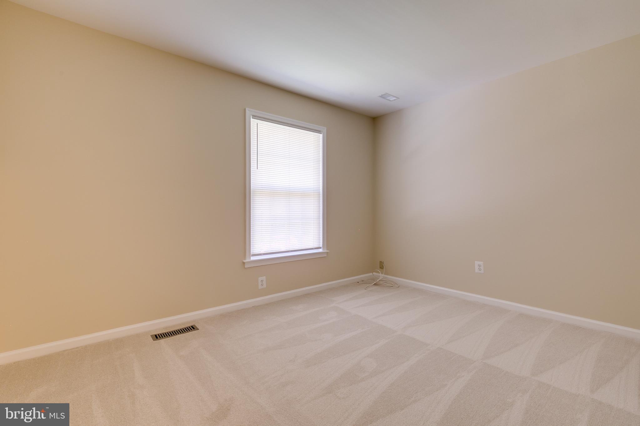 7007 Barnacle Place Burke, VA 22015 - Photo 27 of 49 a view of an empty room with a window