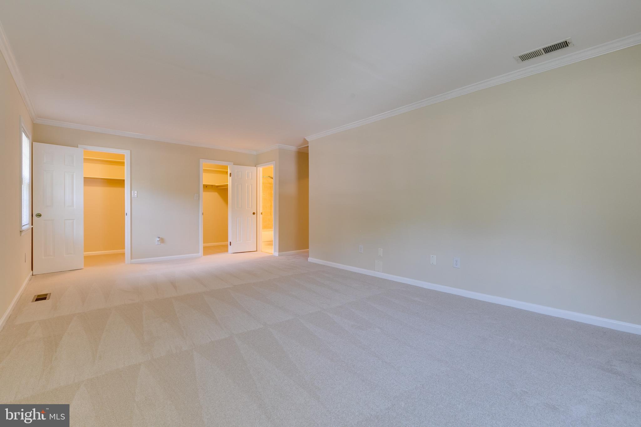 7007 Barnacle Place Burke, VA 22015 - Photo 30 of 49 a view of an empty room with window and a kitchen