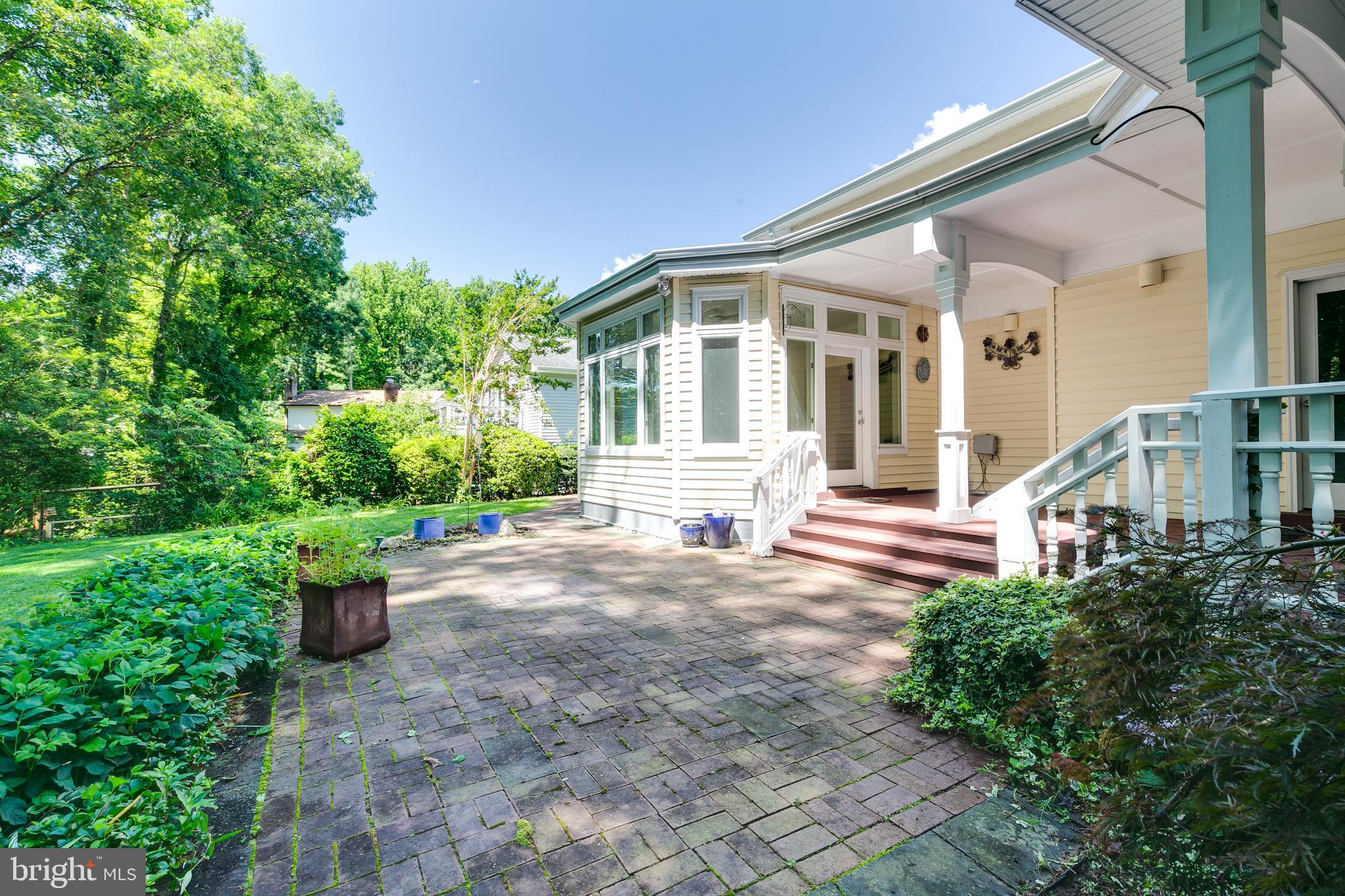 7007 Barnacle Place Burke, VA 22015 - Photo 43 of 49 a front view of a house with a garden and plants