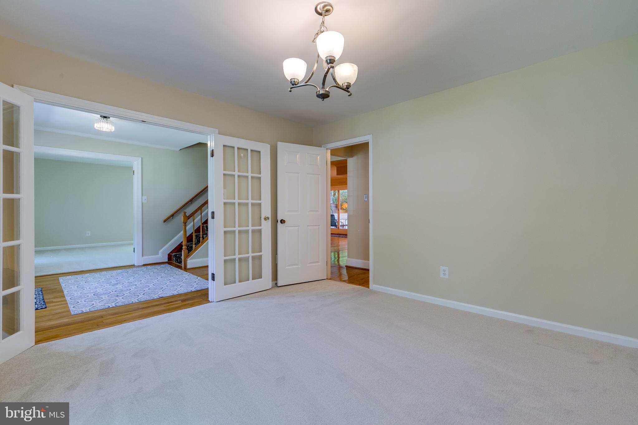 7007 Barnacle Place Burke, VA 22015 - Photo 8 of 49 a view of an empty room with a chandelier