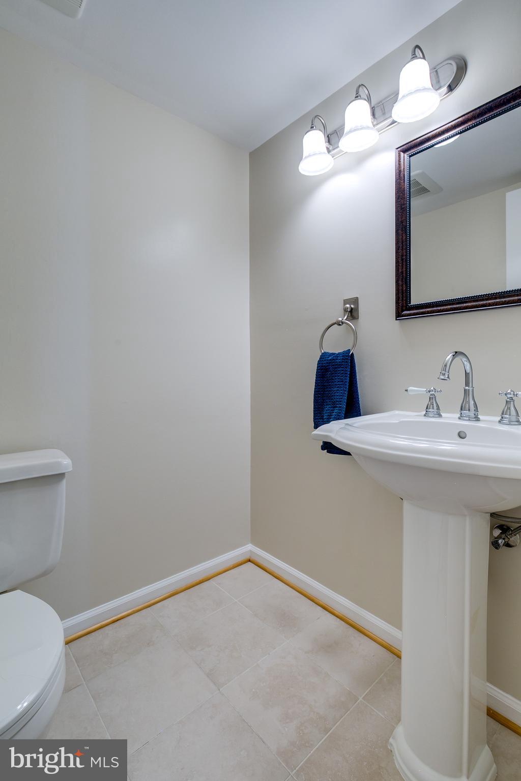 7007 Barnacle Place Burke, VA 22015 - Photo 10 of 49 a bathroom with a sink a toilet and mirror
