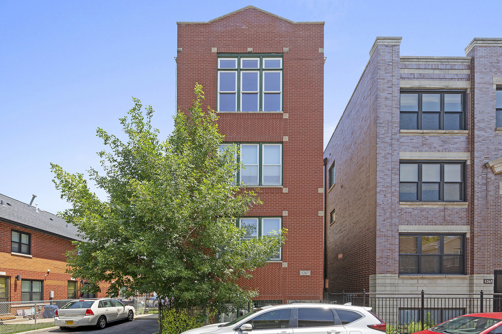 1267 North Honore Street, Unit 3 Chicago, IL 60622 - Photo 1 of 17 a front view of a residential apartment building with a yard