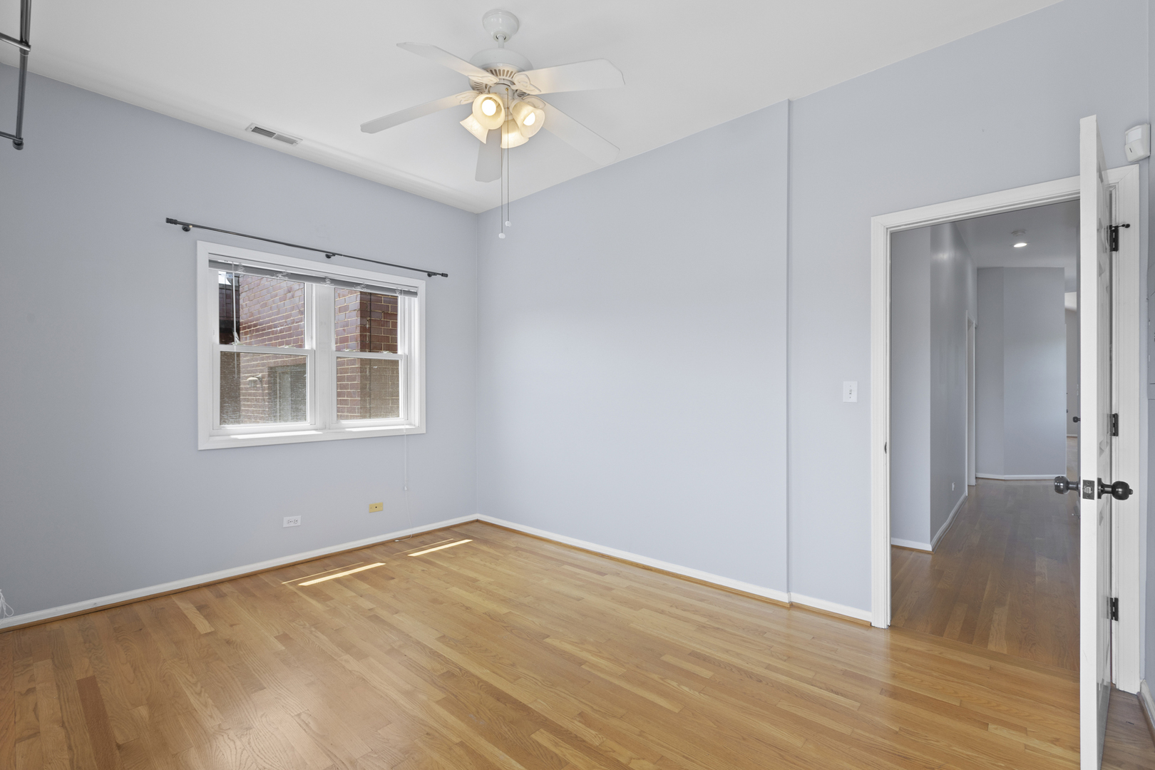 1267 North Honore Street, Unit 3 Chicago, IL 60622 - Photo 11 of 17 a view of empty room with wooden floor and window