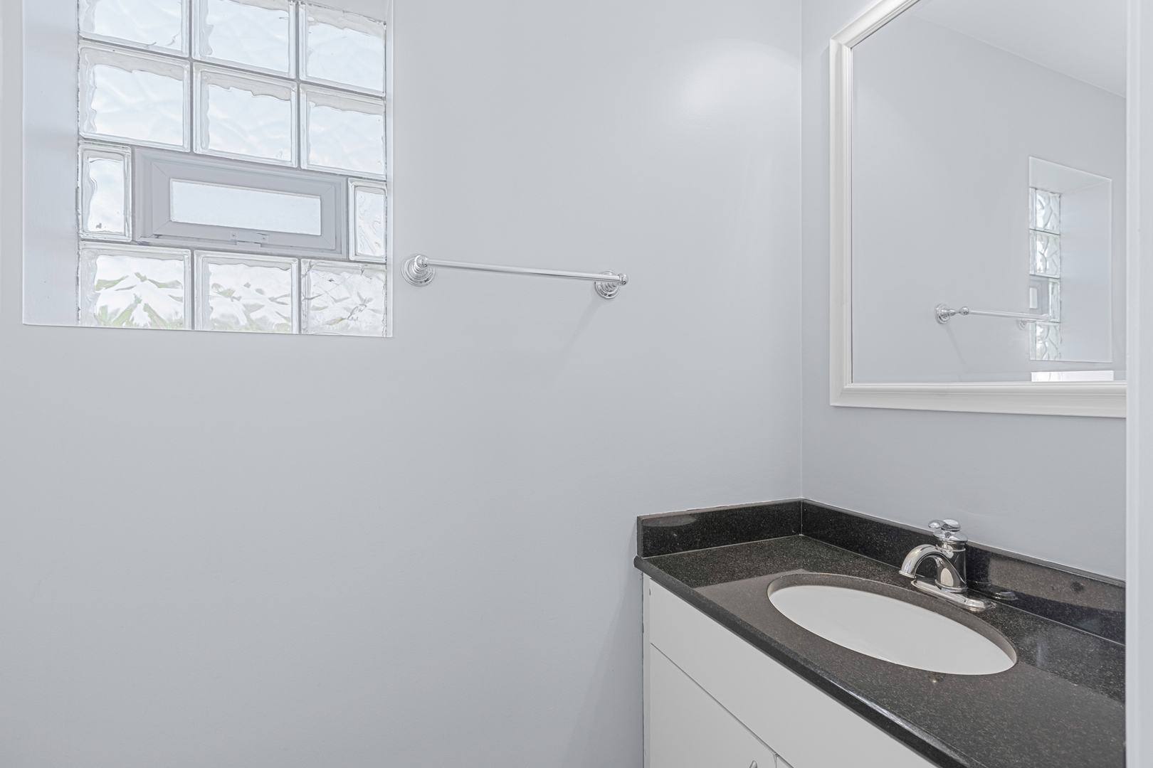 1267 North Honore Street, Unit 3 Chicago, IL 60622 - Photo 12 of 17 a bathroom with a granite countertop sink and a mirror