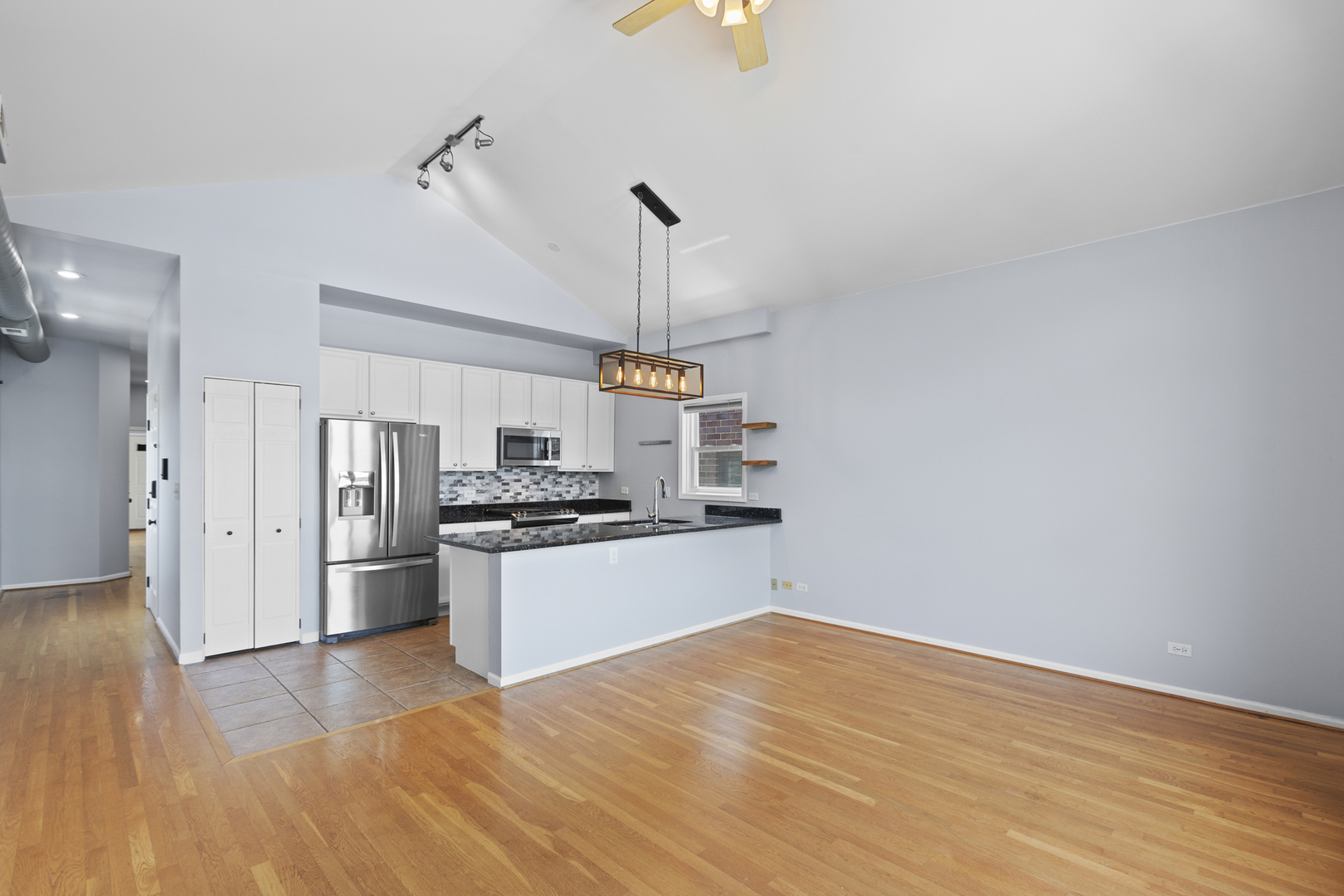1267 North Honore Street, Unit 3 Chicago, IL 60622 - Photo 2 of 17 a kitchen with stainless steel appliances granite countertop a refrigerator and a stove top oven