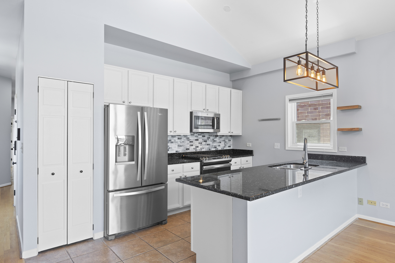 1267 North Honore Street, Unit 3 Chicago, IL 60622 - Photo 6 of 17 a kitchen with stainless steel appliances granite countertop a refrigerator a stove a sink dishwasher and a refrigerator with wooden floor