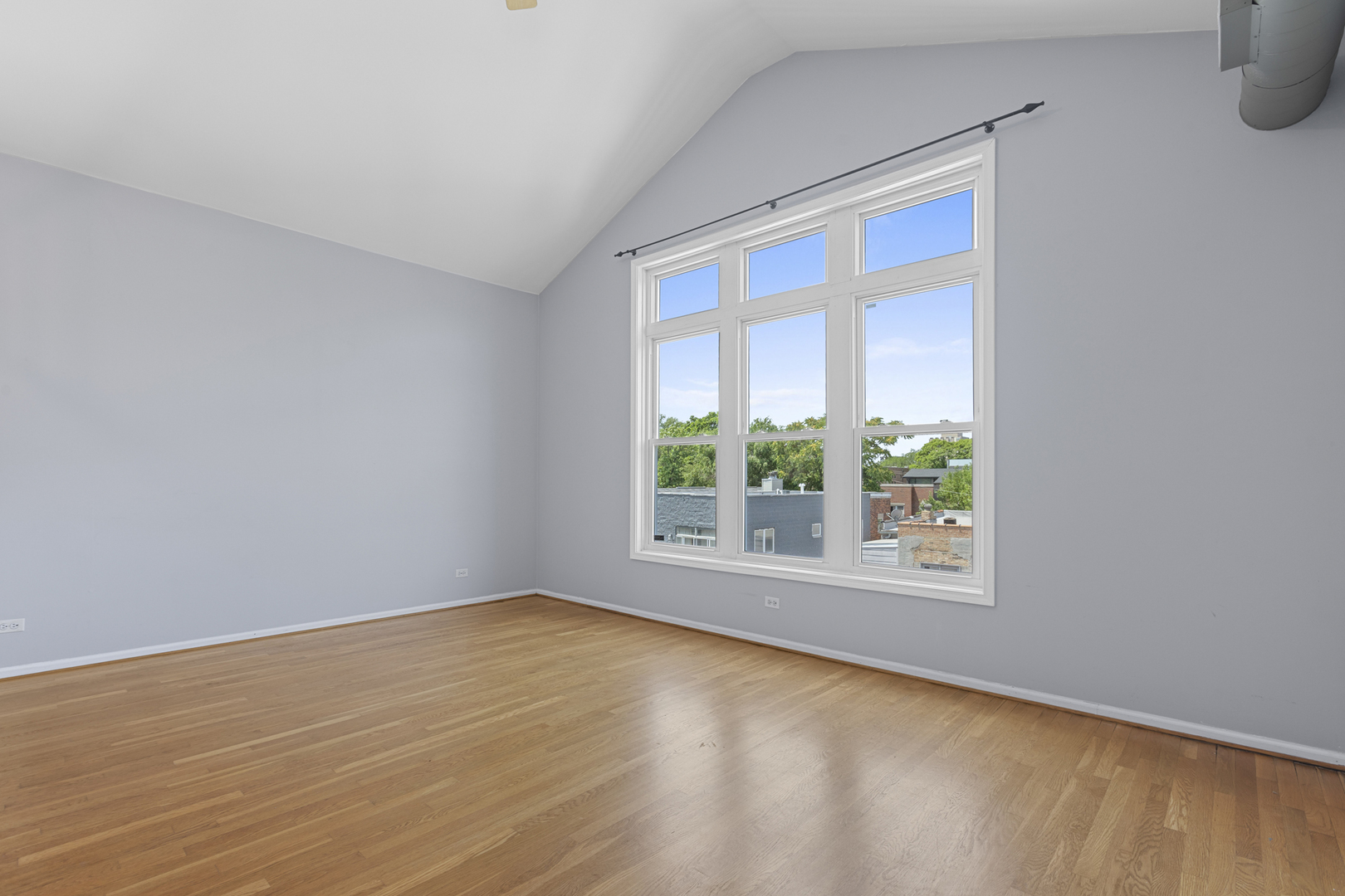 1267 North Honore Street, Unit 3 Chicago, IL 60622 - Photo 7 of 17 wooden floor in an empty room with a window