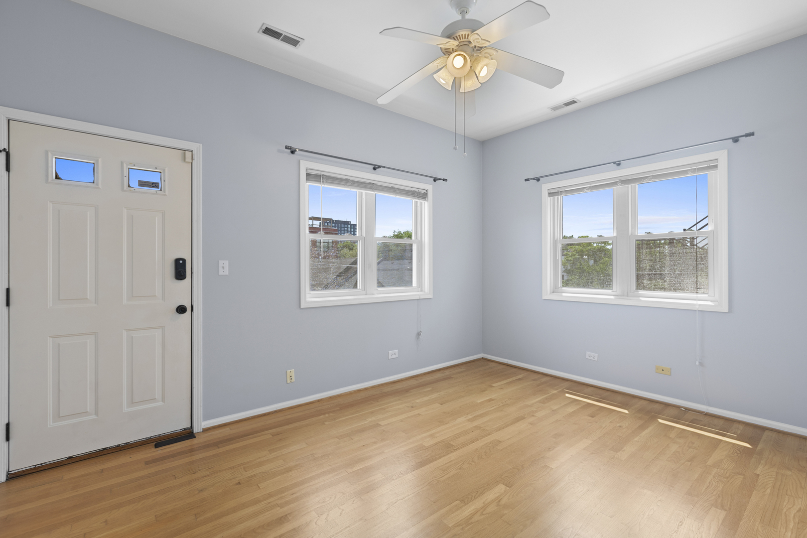 1267 North Honore Street, Unit 3 Chicago, IL 60622 - Photo 10 of 17 a view of empty room with wooden floor and fan