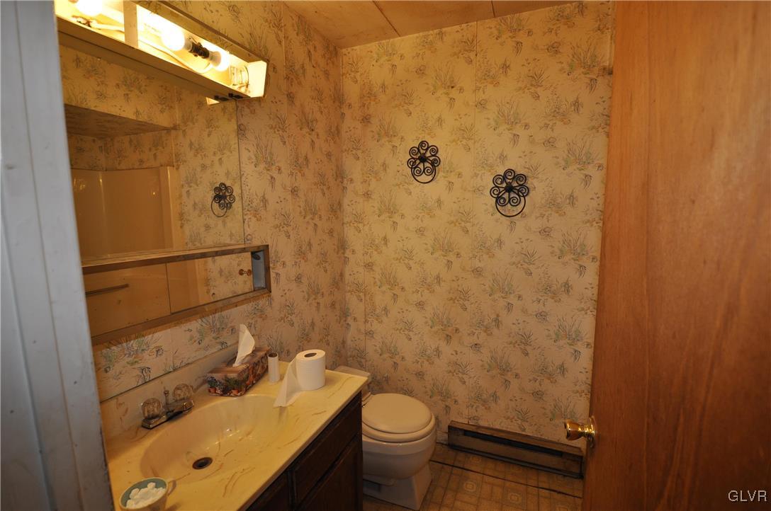 205 Longley Road Nazareth, PA 18064 - Photo 10 of 23 a bathroom with a sink and mirror with toilet