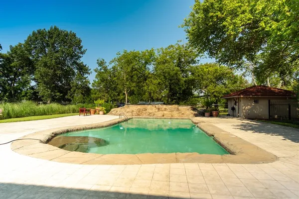 a view of a swimming pool with a patio